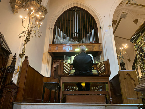 a man plays the organ inside Christ Episcopal Church in Reading, PA